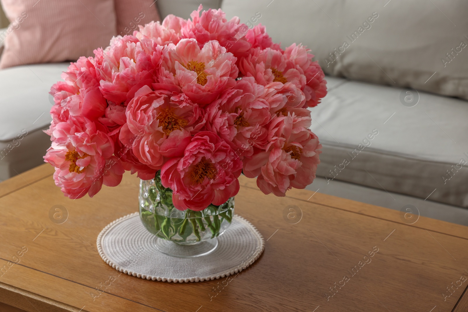 Photo of Beautiful pink peonies in vase on table at home. Interior design