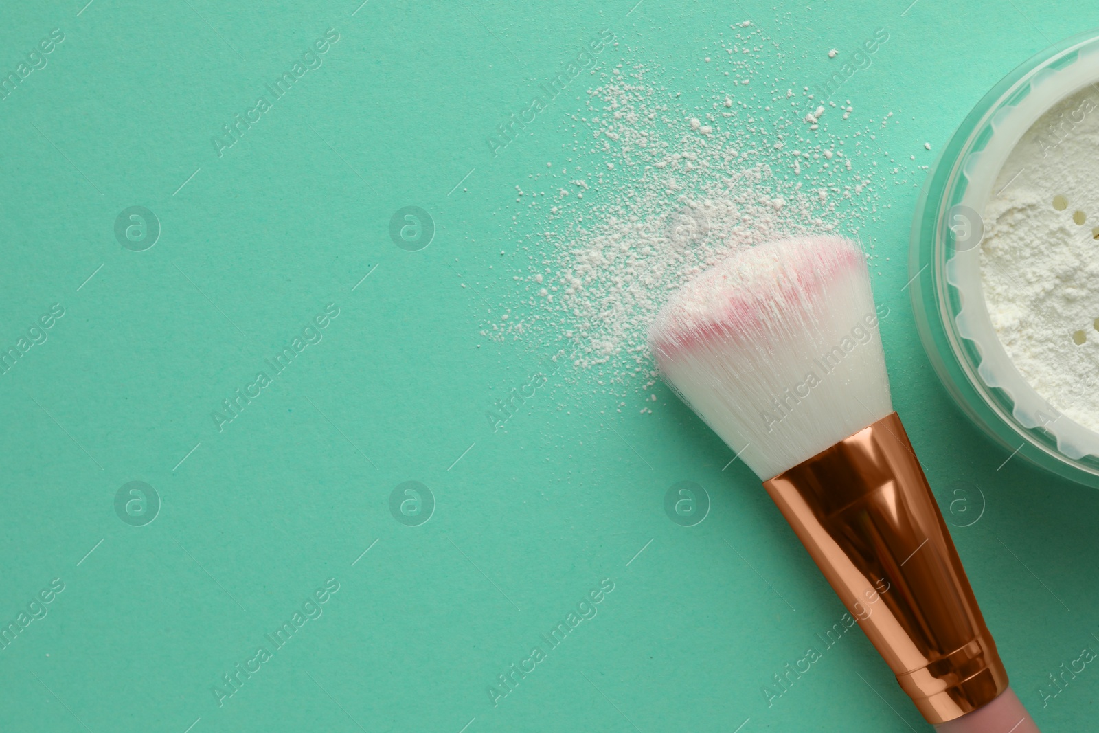 Photo of Rice loose face powder and makeup brush on turquoise background, flat lay. Space for text