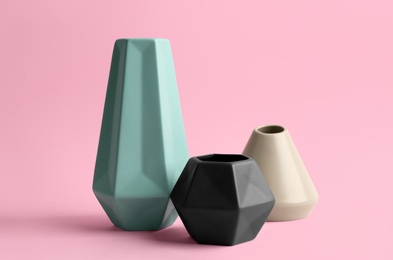 Photo of Stylish empty ceramic vases on pink background