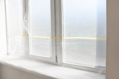 Photo of Windows covered with polyethylene film. Protection during repair