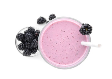 Tasty fresh milk shake and blackberries on white background, top view