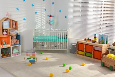 Cozy baby room interior with comfortable crib