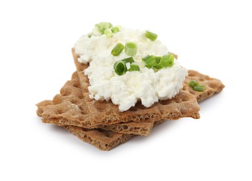Photo of Crispy crackers with cottage cheese and green onion on white background
