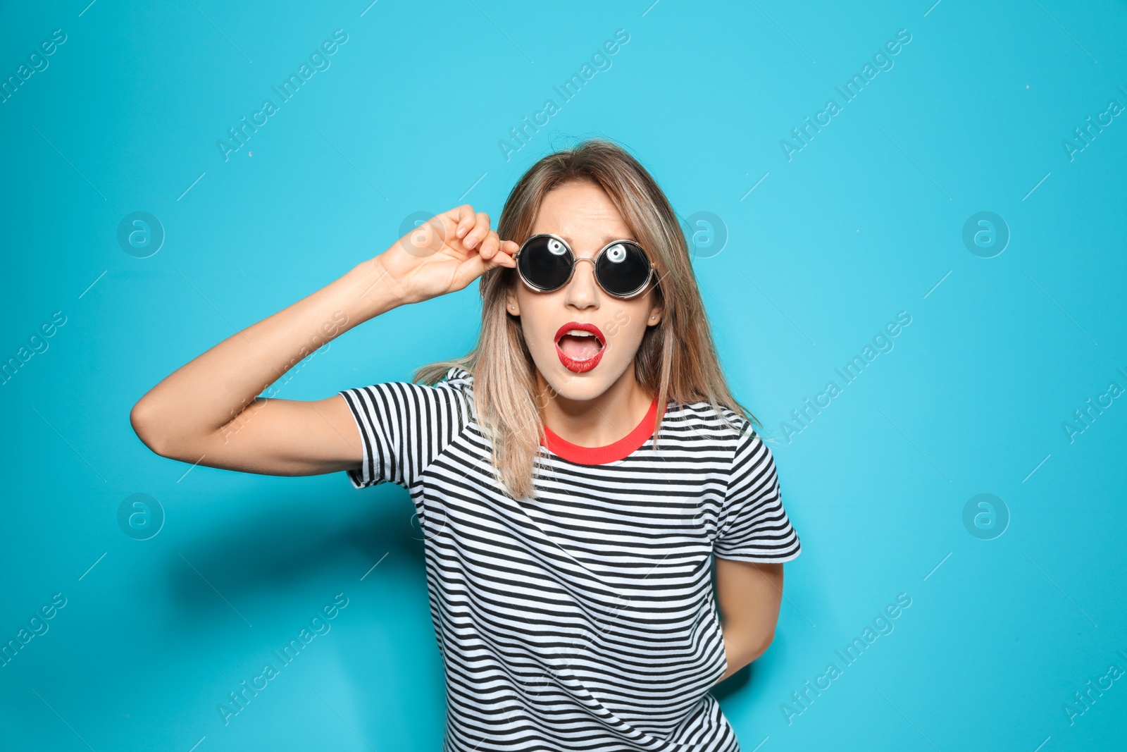 Photo of Beautiful young woman with healthy long blonde hair on color background