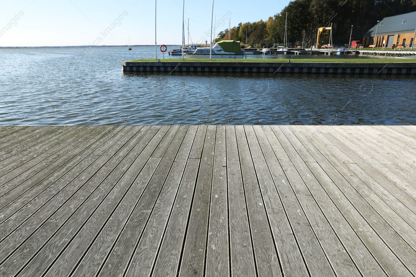 Photo of Beautiful view of wooden terrace near river on sunny day