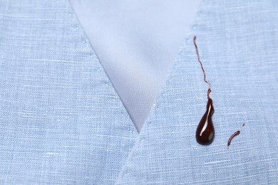Photo of Dirty vest with drops of chocolate, closeup view
