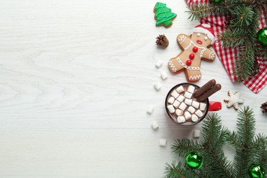 Photo of Delicious hot chocolate with marshmallows and cocoa sticks near Christmas decor on white wooden table, flat lay. Space for text
