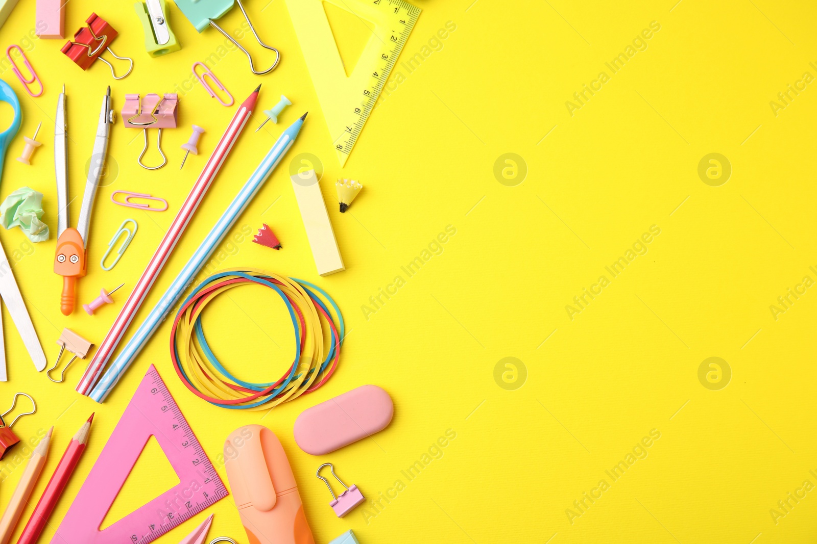 Photo of Flat lay composition with different school stationery on yellow background, space for text. Back to school