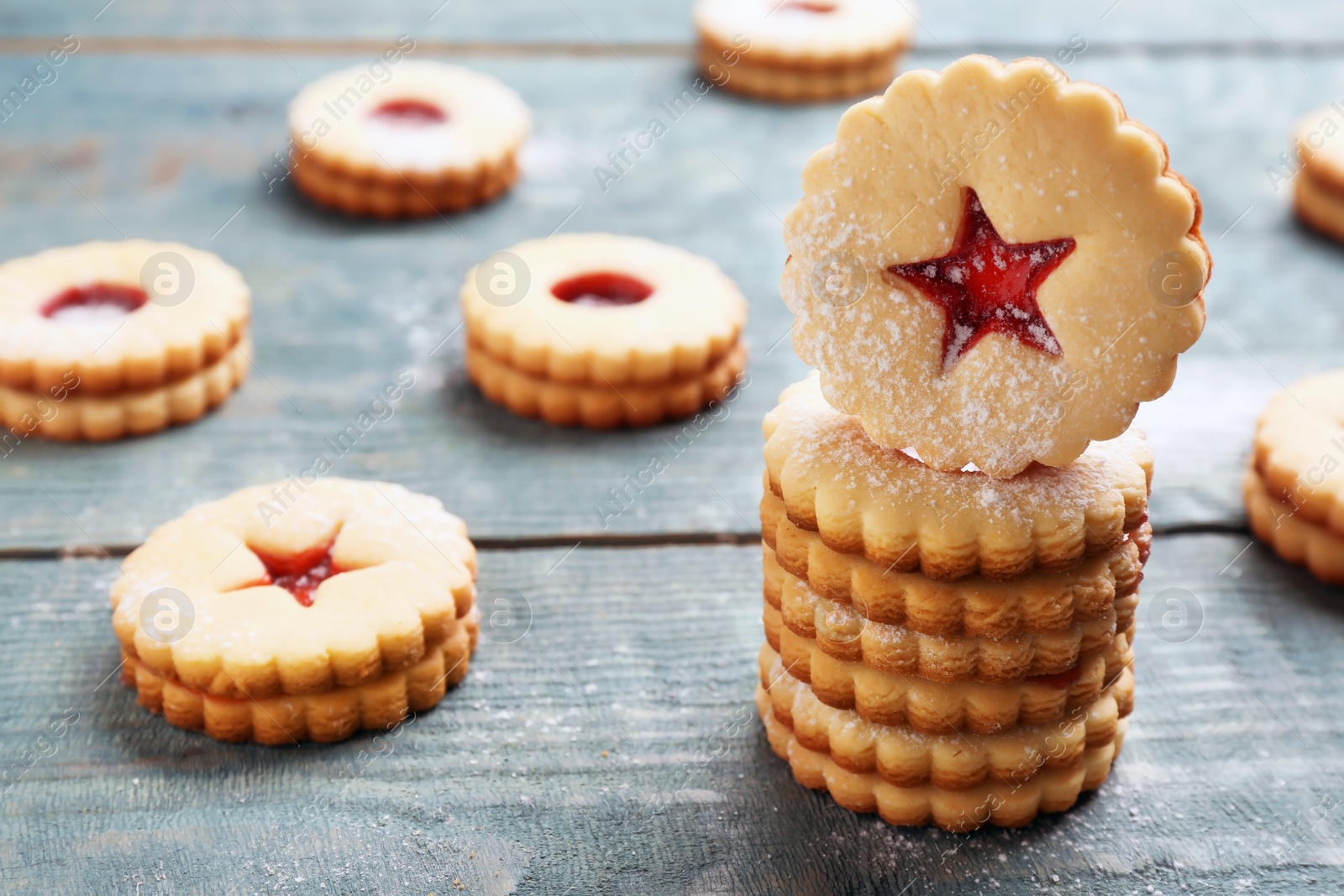 Photo of Traditional Christmas Linzer cookies with sweet jam on wooden background