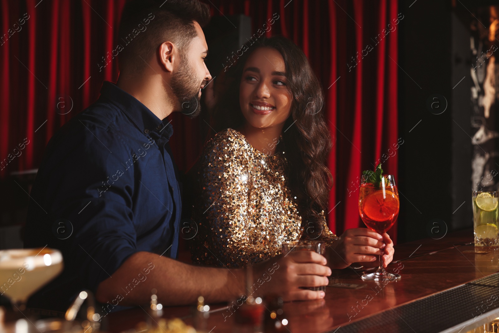 Photo of Lovely couple with fresh cocktails at bar counter