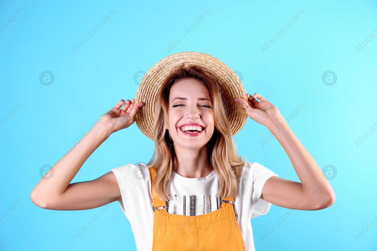 Photo of Portrait of beautiful laughing woman on color background