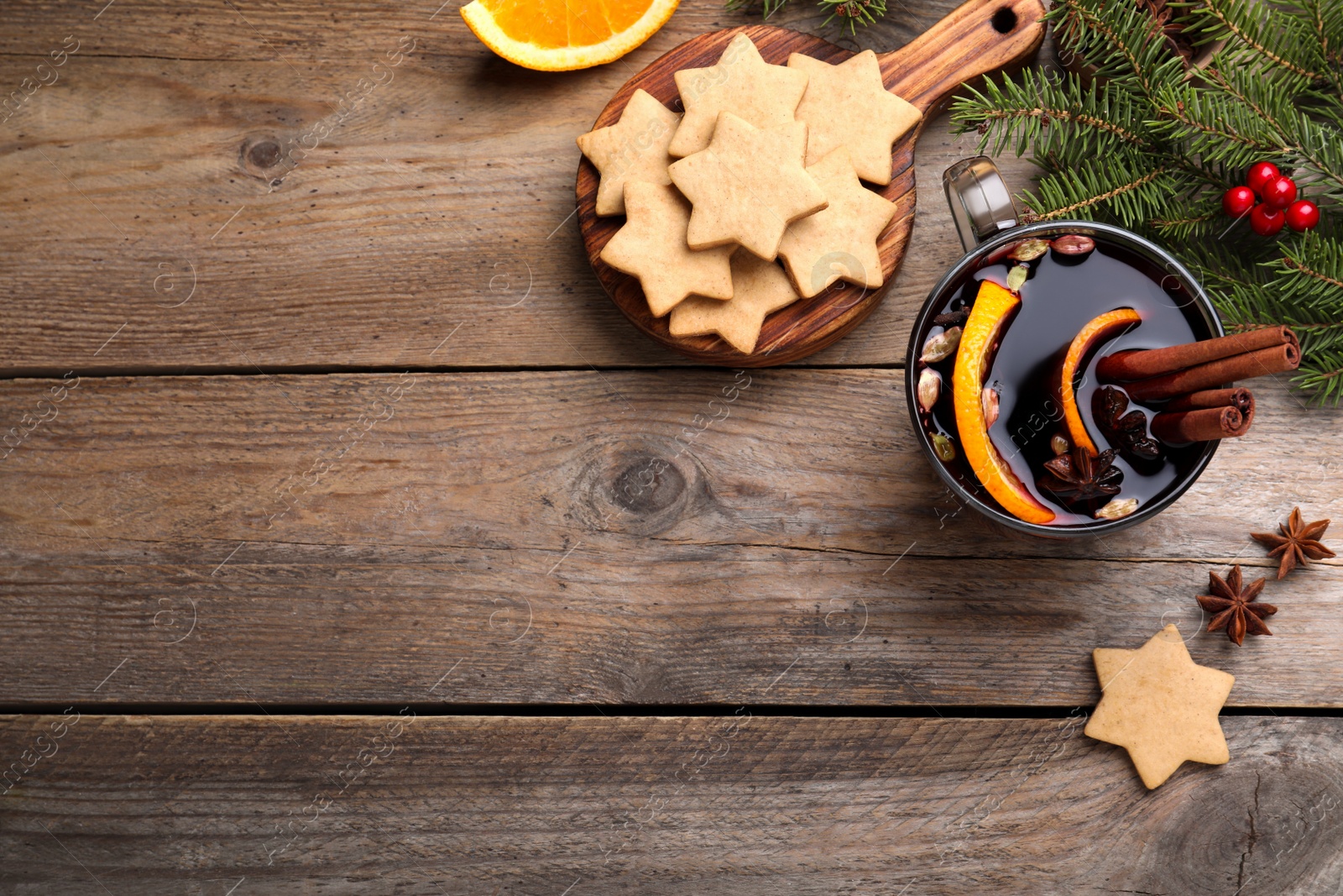 Photo of Flat lay composition with aromatic mulled wine on wooden table, space for text