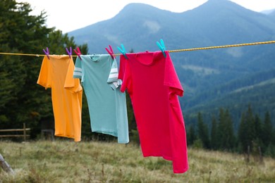 Photo of Clothes hanging on washing line in mountains