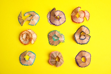 Pencil shavings on yellow background, flat lay