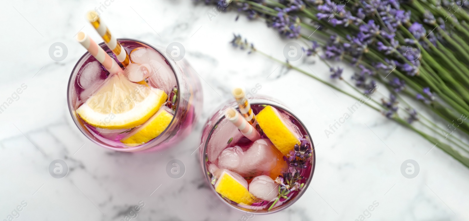 Image of Fresh delicious lemonade with lavender on white marble table, top view