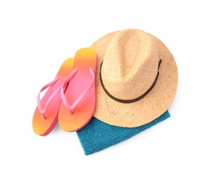 Photo of Straw hat, towel and flip flops isolated on white, above view. Beach objects