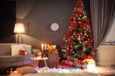 Photo of Blurred view of stylish room interior with decorated Christmas tree