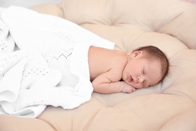 Adorable newborn baby sleeping in bed