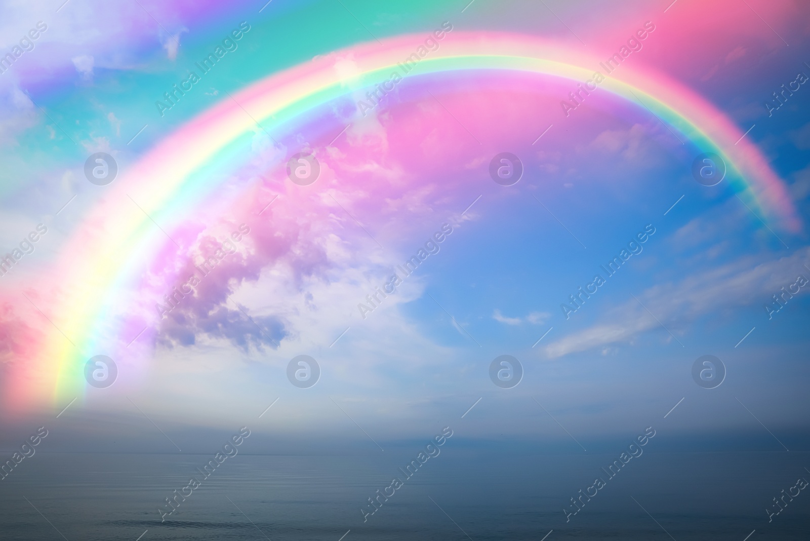 Image of Beautiful view of colorful rainbow in sky over sea