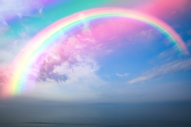 Image of Beautiful view of colorful rainbow in sky over sea