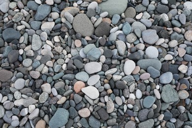 Many different pebbles as background, top view