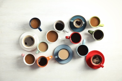 Photo of Flat lay composition with cups of coffee on light background. Food photography