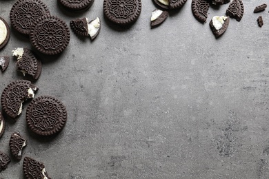 Tasty chocolate cookies on grey background, flat lay with space for text