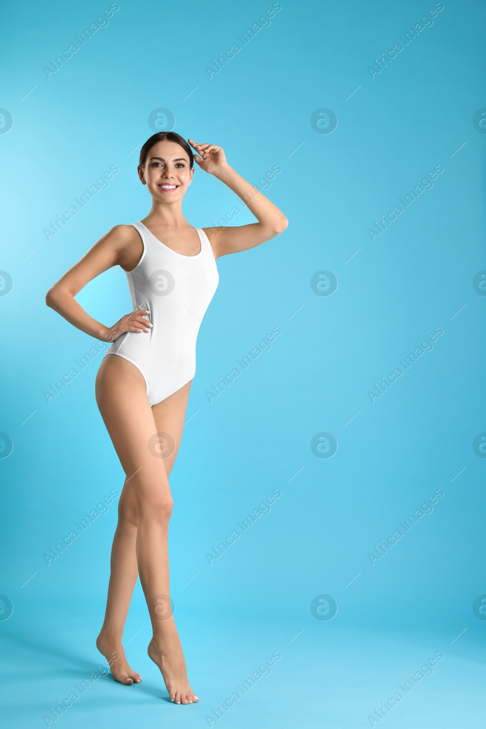 Photo of Full length portrait of attractive young woman with slim body in swimwear on color background. Space for text