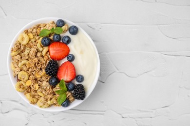 Photo of Tasty oatmeal, yogurt and fresh berries in bowl on white textured table, top view with space for text. Healthy breakfast