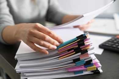 Photo of Office employee working with documents at table, closeup