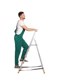 Worker in uniform climbing up metal ladder on white background