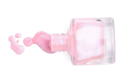 Photo of Overturned bottle of pink nail polish isolated on white, top view