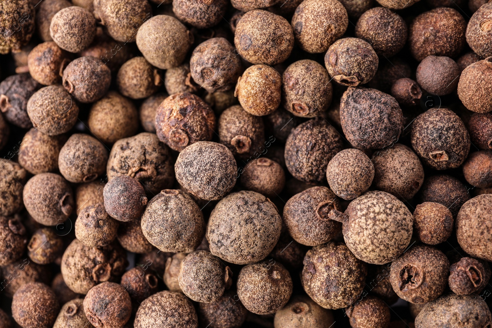 Photo of Black pepper grains as background, top view