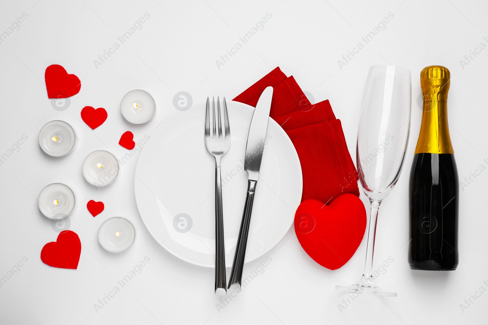 Photo of Beautiful table setting with sparkling wine and burning candles for romantic dinner on white background, flat lay