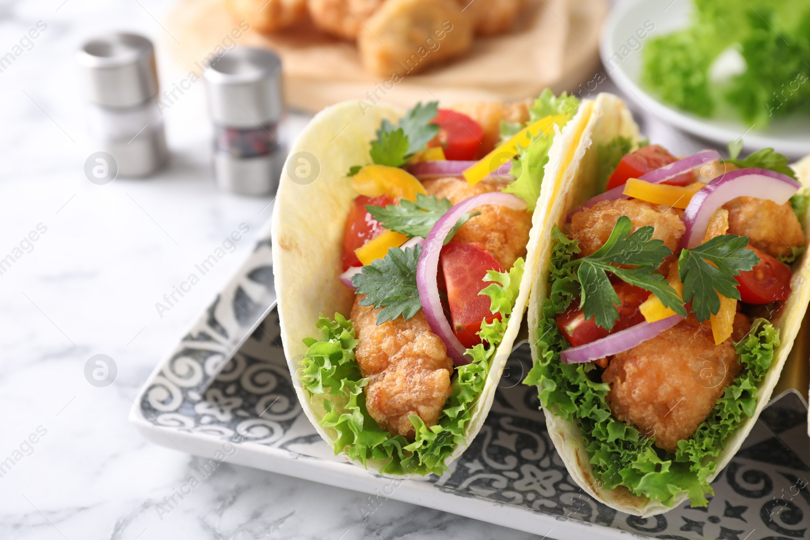 Photo of Yummy fish tacos served on table, closeup