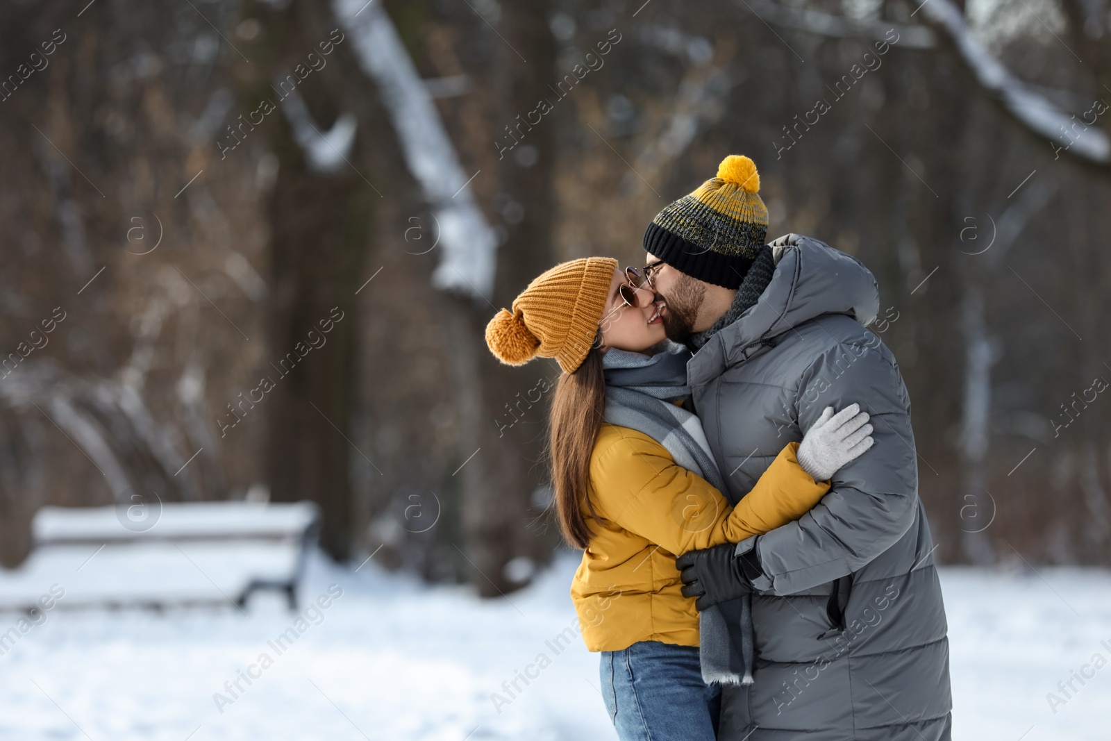 Photo of Beautiful happy couple outdoors on winter day. Space for text