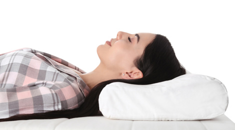 Young woman sleeping on orthopedic pillow against white background, closeup