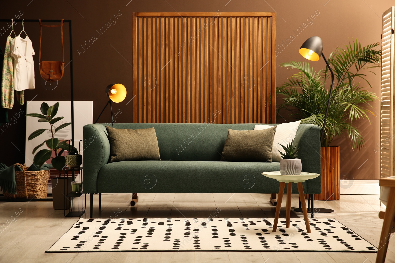 Photo of Living room with comfortable green sofa. Interior design