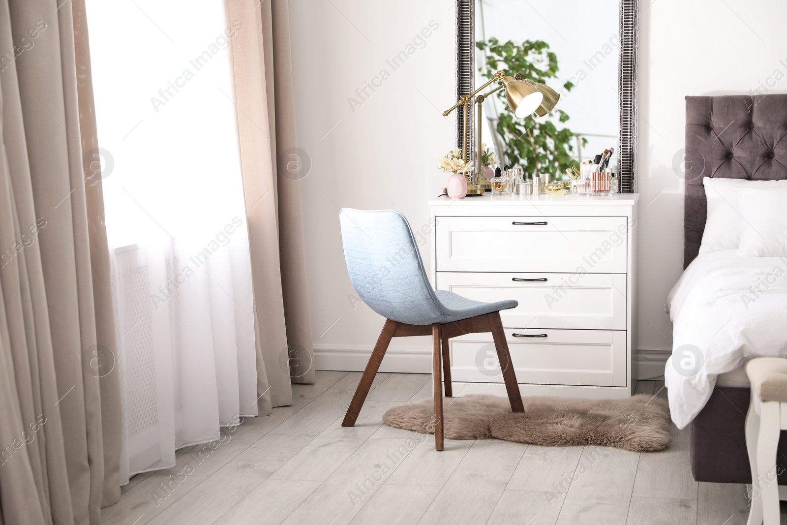 Photo of Interior of bedroom with dressing table near wall