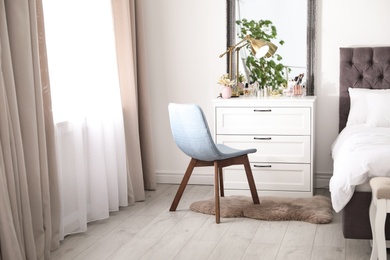 Photo of Interior of bedroom with dressing table near wall