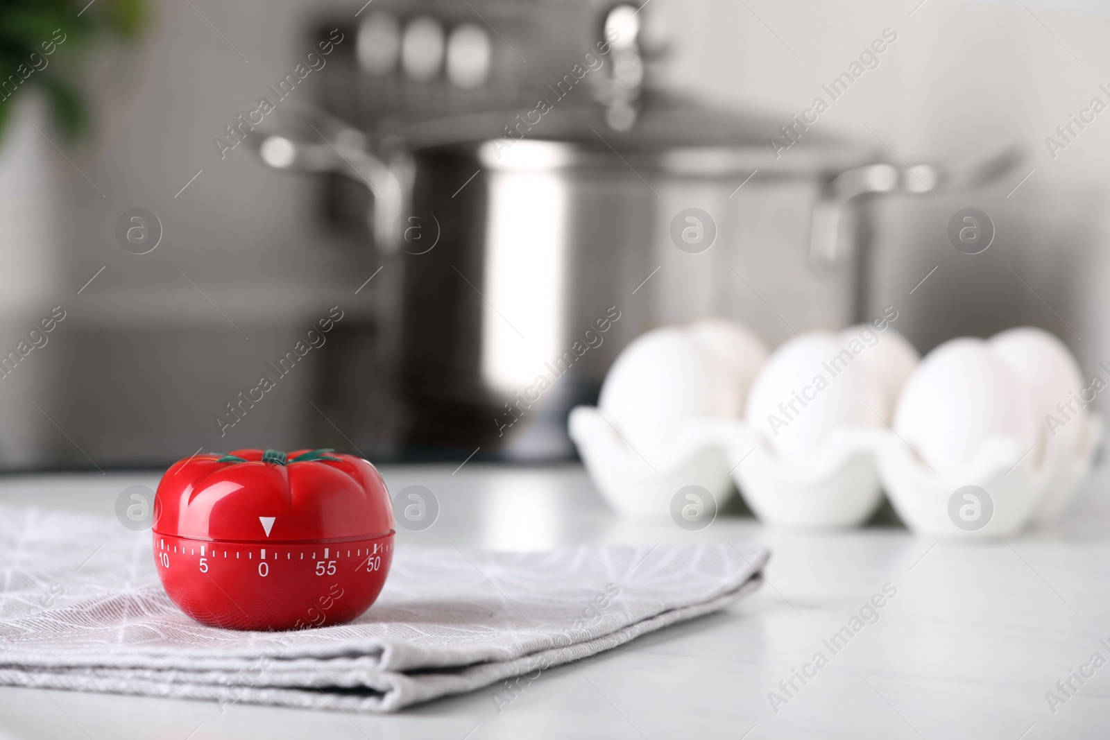 Photo of Kitchen timer in shape of tomato on white table indoors. Space for text