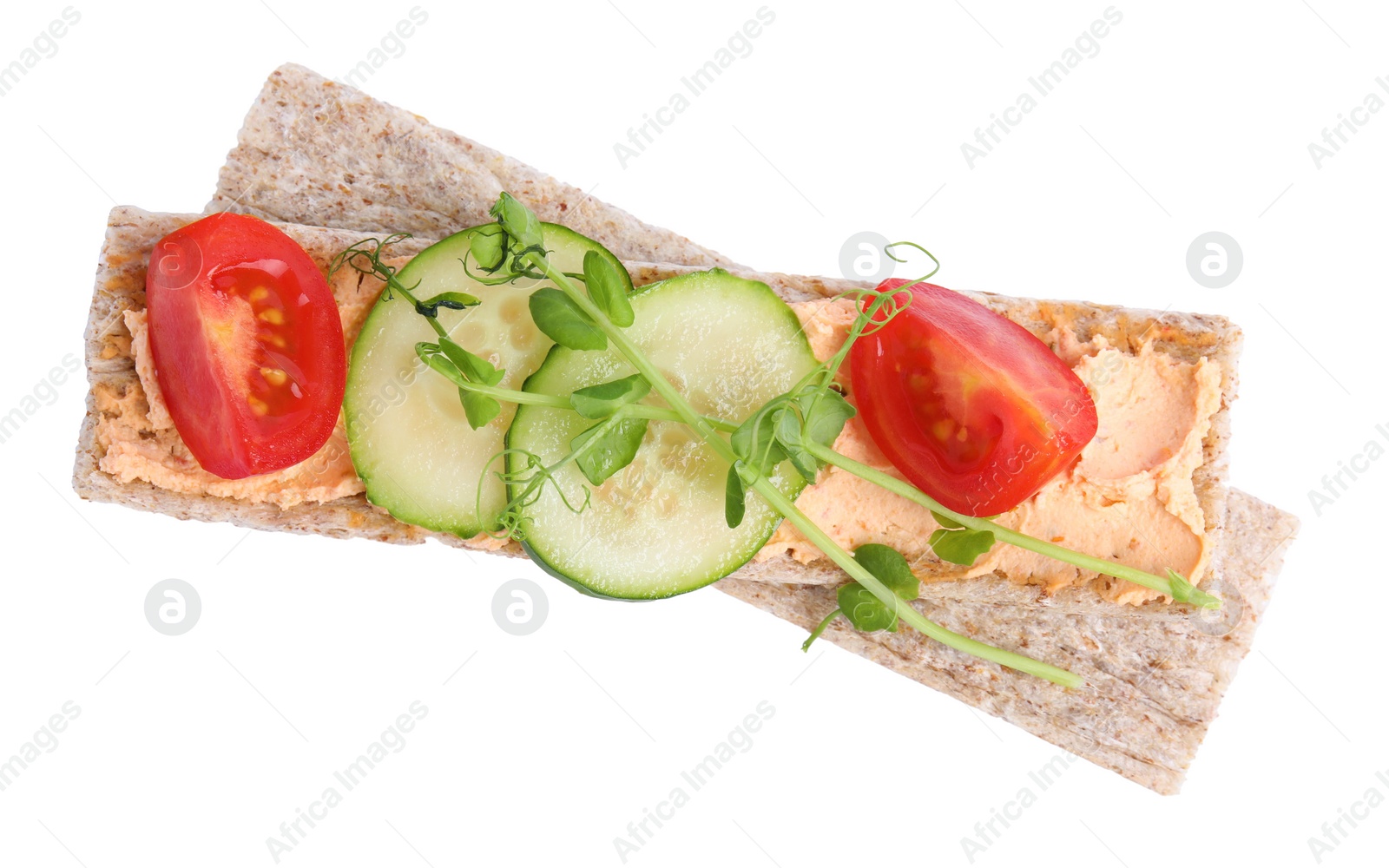 Photo of Tasty crispbreads with cream cheese and fresh vegetables isolated on white, top view