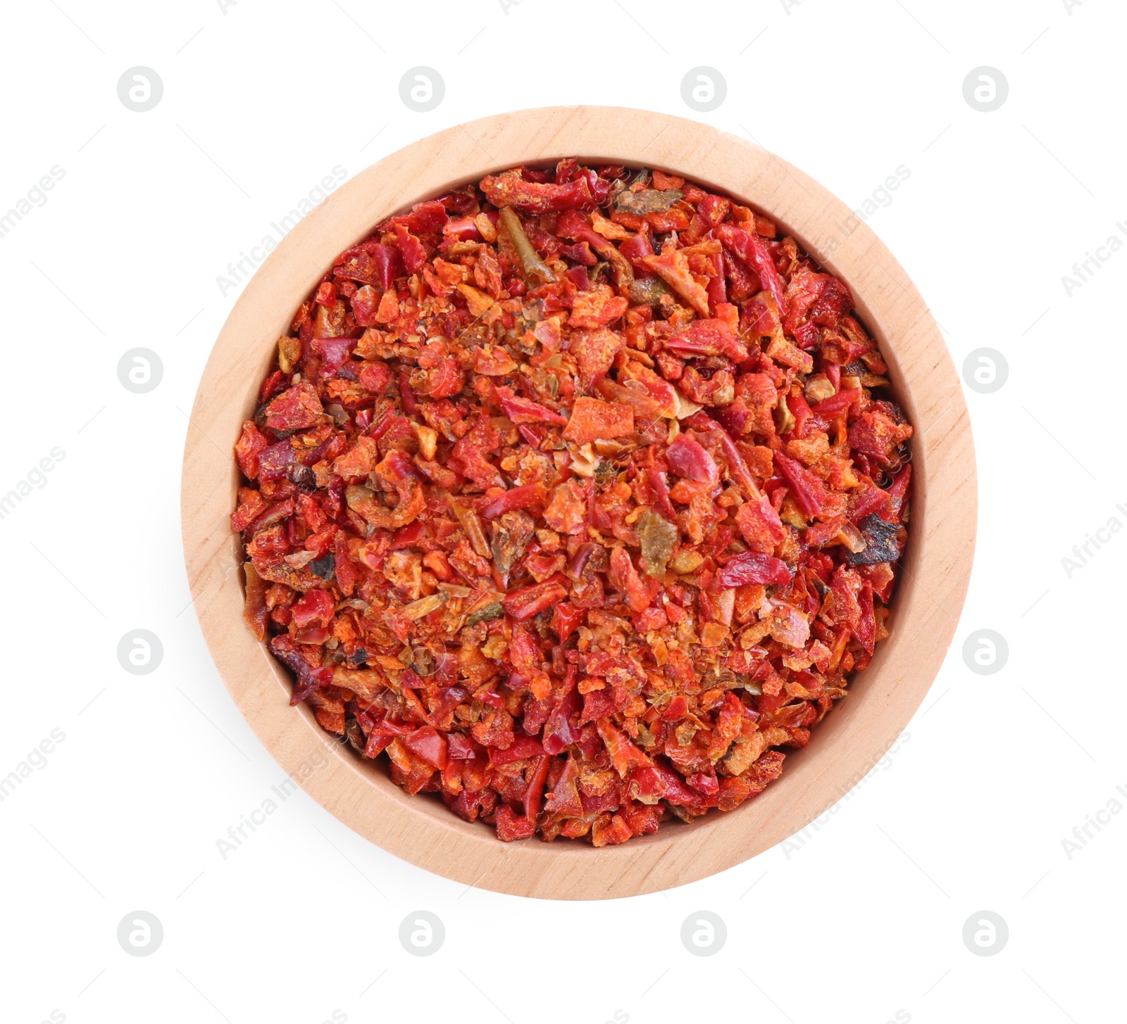 Photo of Aromatic spice. Red chili pepper flakes in bowl isolated on white, top view