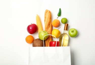 Photo of Flat lay composition with shopping bag and products on white background