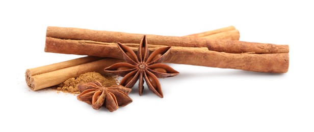 Photo of Dry aromatic cinnamon sticks, powder and anise stars isolated on white