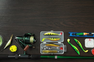 Photo of Fishing tackle on dark wooden background, flat lay. Space for text