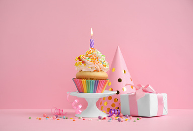 Photo of Composition with birthday cupcake on pink background
