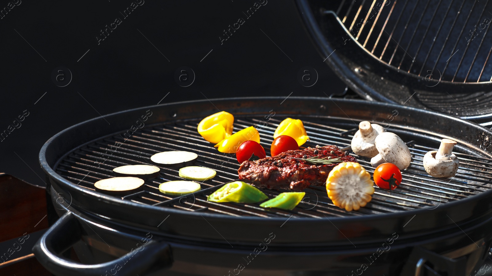 Photo of Tasty steak and vegetables on modern barbecue grill