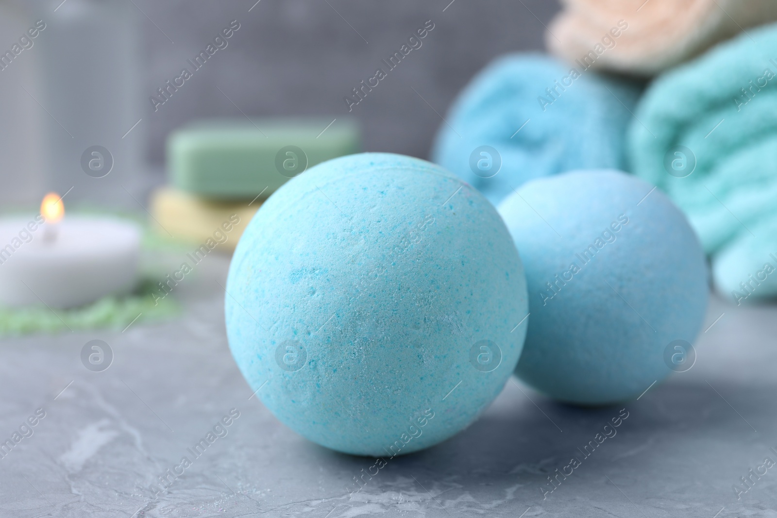 Photo of Beautiful aromatic bath bombs on light grey table, closeup