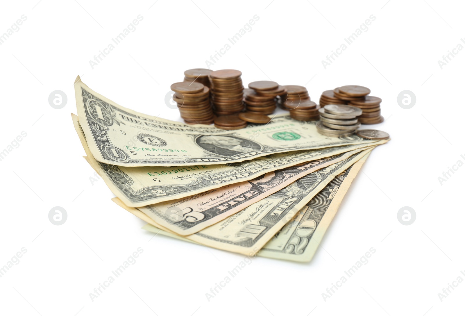 Photo of Dollar banknotes and stacks of coins on white background